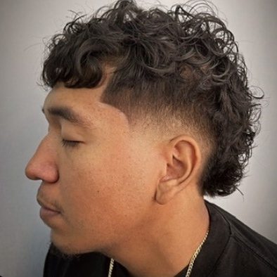Curly mullet with a taper and razor line-up
