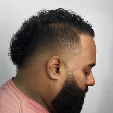 Curls left long on top with a shaped, blended beard