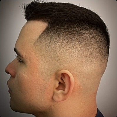 Skin fade with a hard part cut into the line